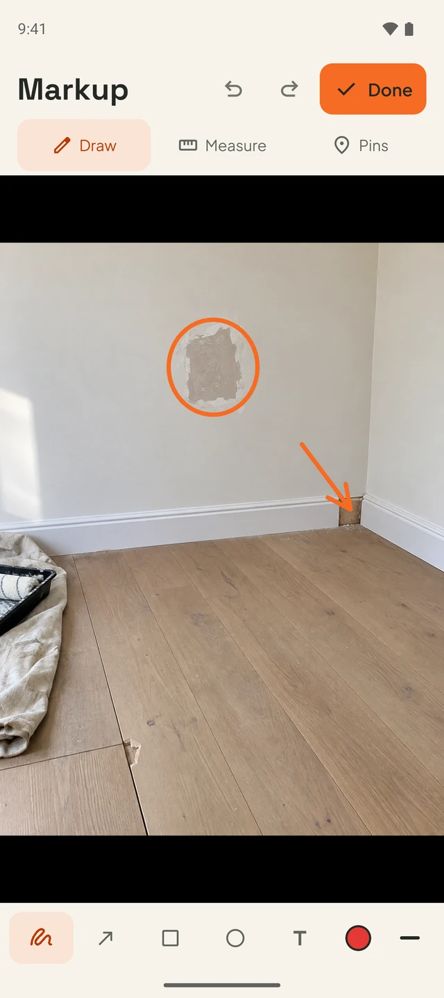Circle unfinished plaster and point to missing skirting in a room renovation photo